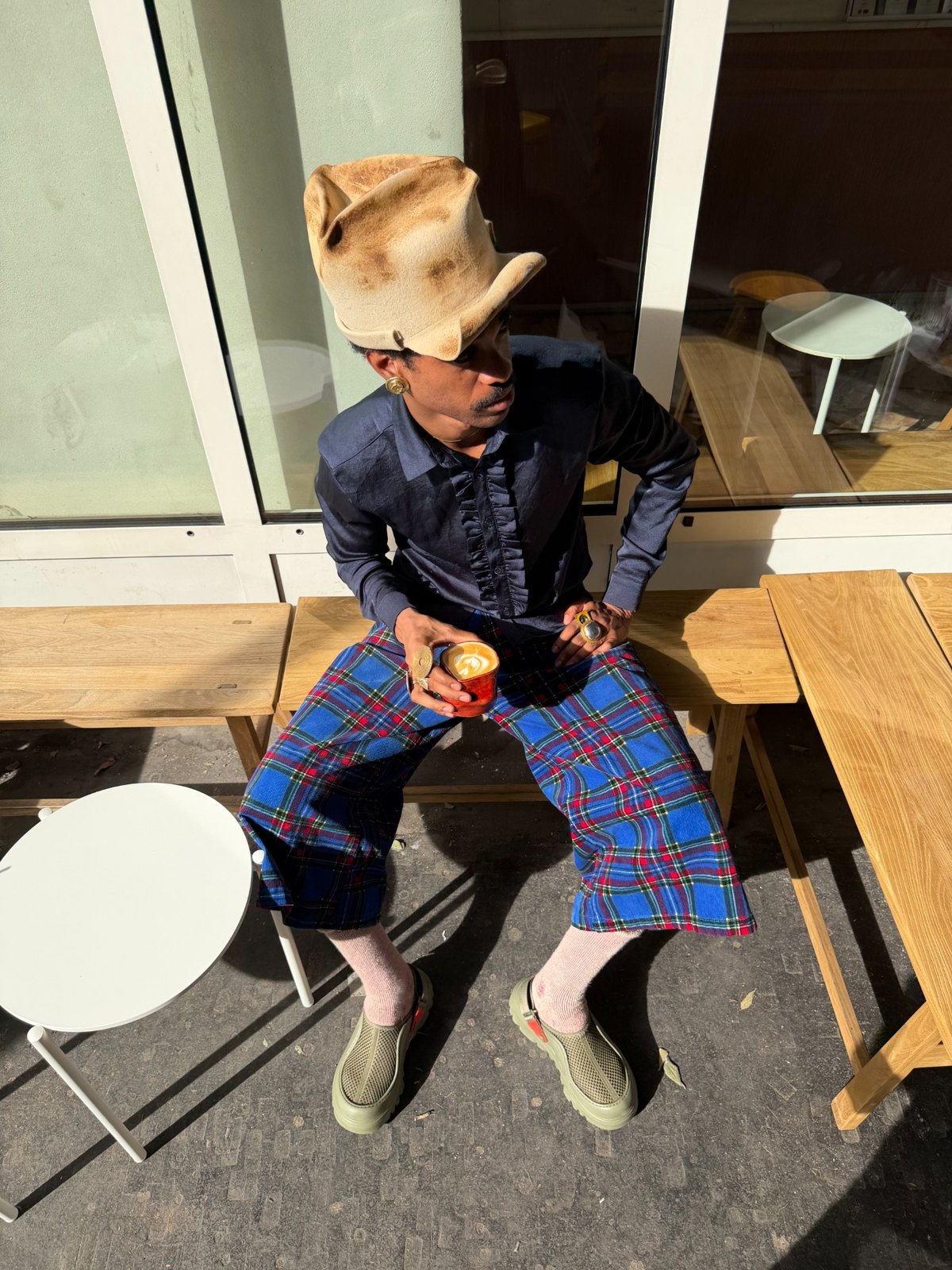 Creator photographed sitting outdoors